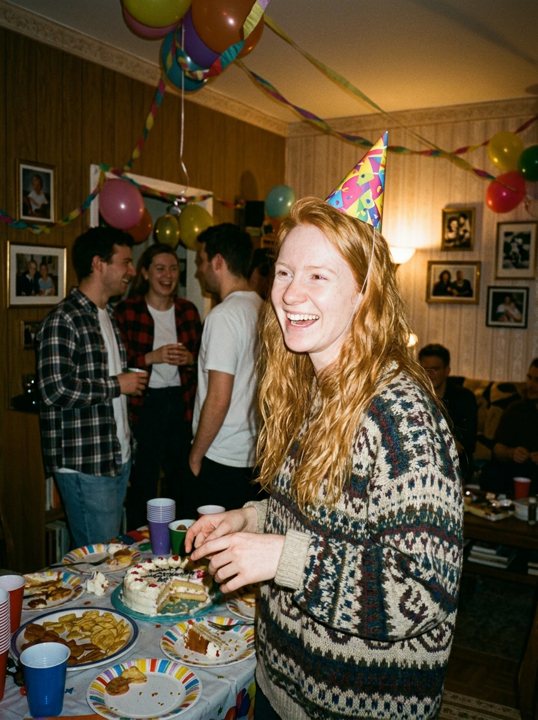 A woman laughing at her birthday party